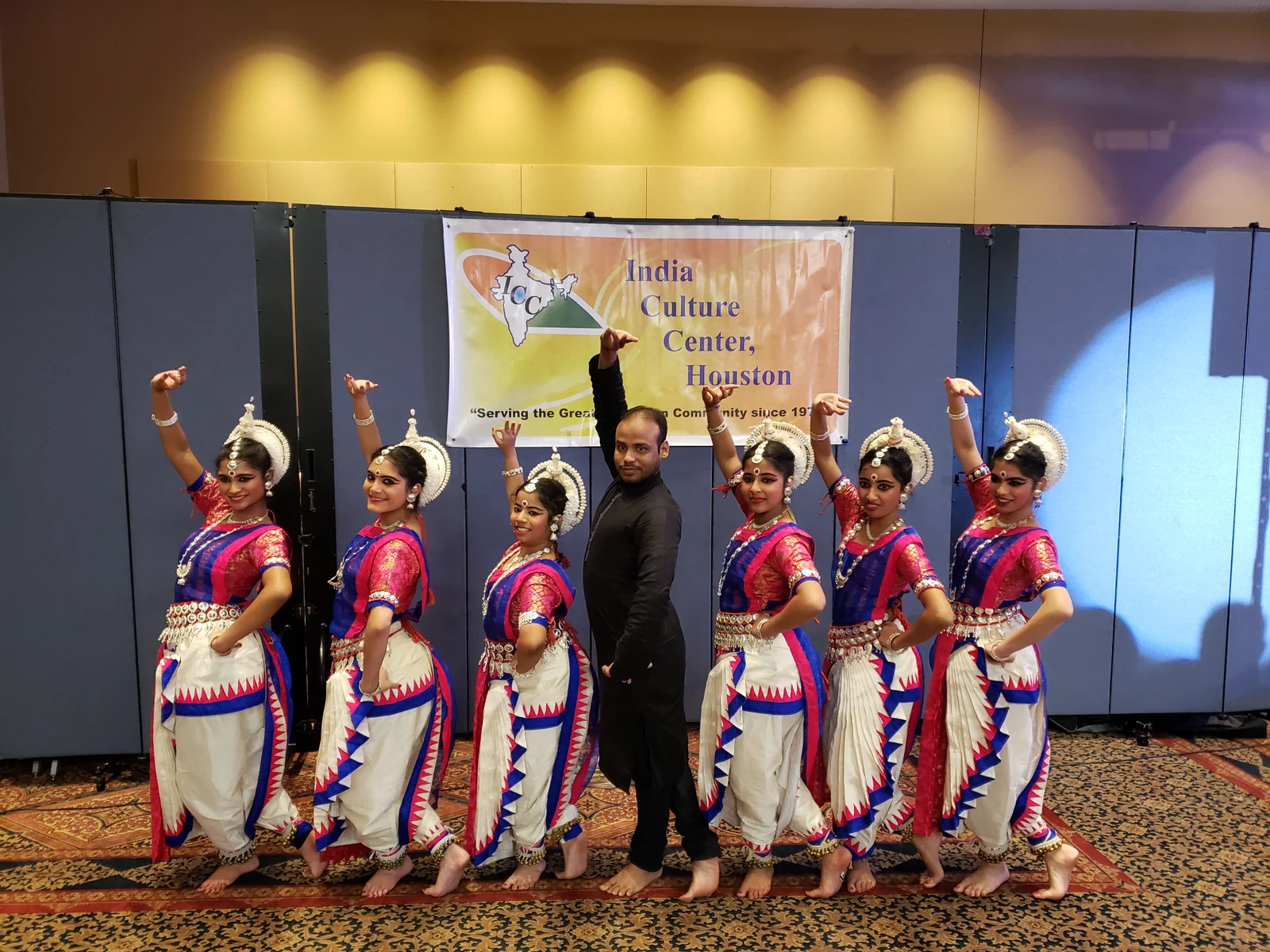 Odissi dancers in traditional attire performing with grace and poise