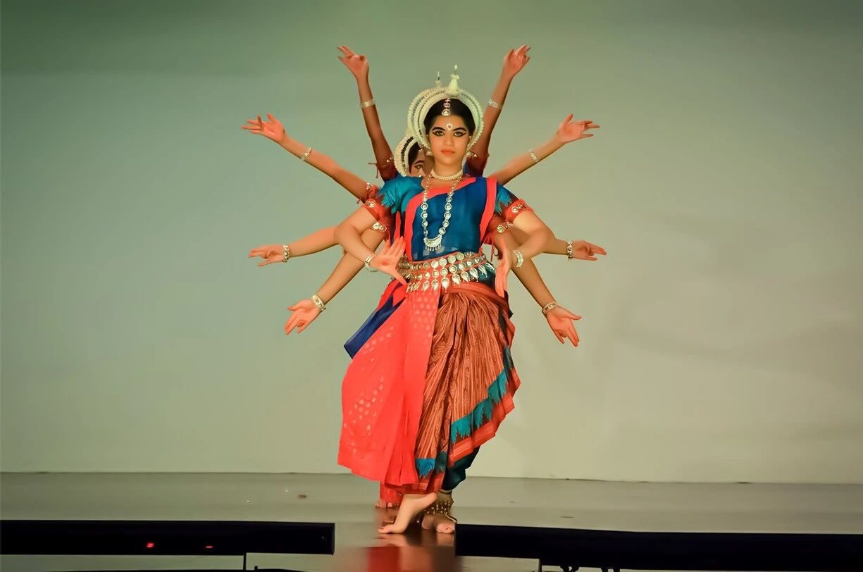A synchronized group performance of Odissi dancers